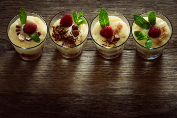 Dessert with berries, jelly, cream, nuts and mint leaf 