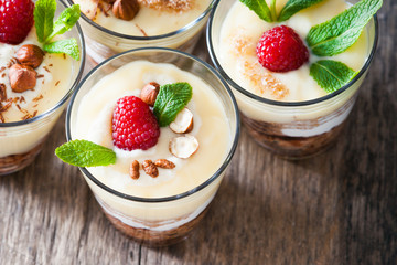 Dessert with berries, jelly, cream, nuts and mint leaf 