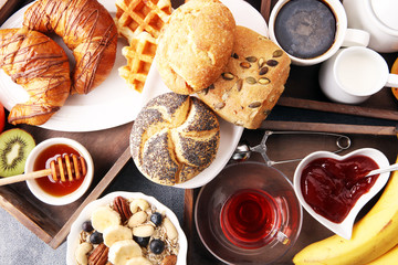 Breakfast served with coffee, orange juice, croissants and fruits. Balanced diet.