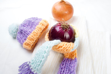 Concept of flu sick person with cap and scarf with healthy tea, fruit and vegetable