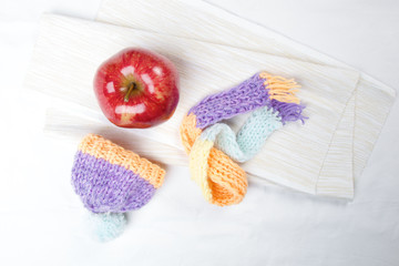 Concept of flu sick person with cap and scarf with healthy tea, fruit and vegetable