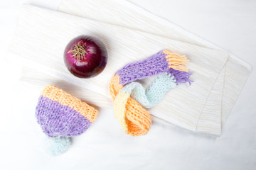 Concept of flu sick person with cap and scarf with healthy tea, fruit and vegetable