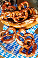 pretzels on wooden table with blue white bavarian napkin