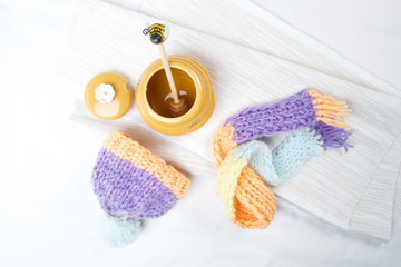 Concept of flu sick person with cap and scarf with healthy tea, fruit and vegetable