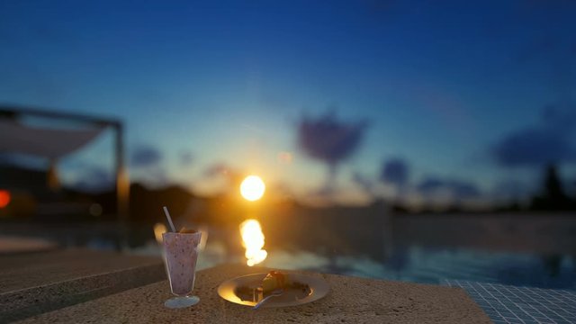 Villa with infinity pool and people relaxing, focus on breakfast, beautiful sunrise, 4K
