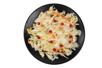 salad sauerkraut with cranberries in black plate isolated on white background