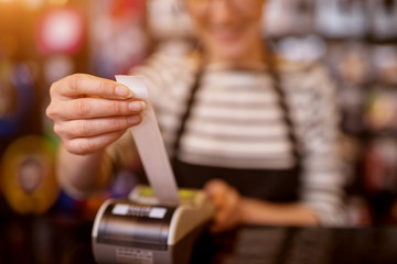 Close up focus view of woman while pulling out a check from the cashier
