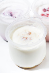 Obraz na płótnie Canvas assortment of yogurts with fruit additives, vertical closeup