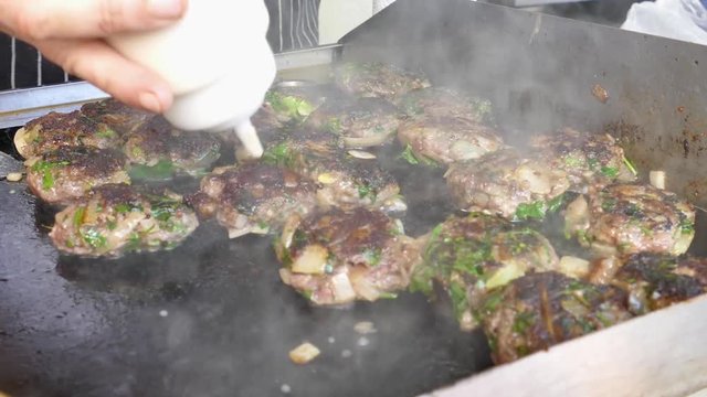 Fresh lamb kebabas on a flattop grill (Plancha) - Street food in the making 