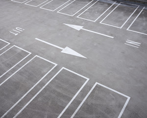 white lines of parking lots and arrows in dutch parking garage - Powered by Adobe
