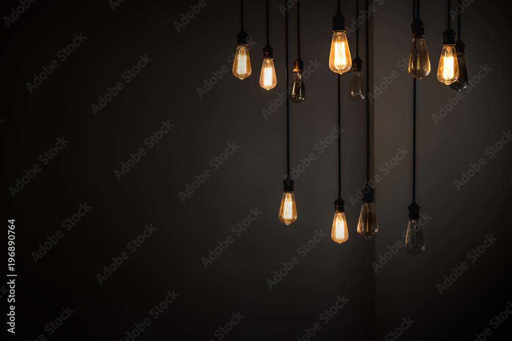 Wall mural idea concept with good and broken light bulbs hanging from ceiling