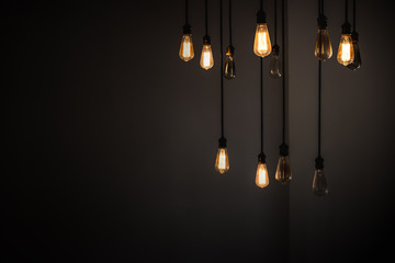 Idea concept with good and broken light bulbs hanging from ceiling