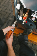 Metallurgy heavy industry. Factory for production of heavy pellet stoves and boilers. Manual worker assembling products.