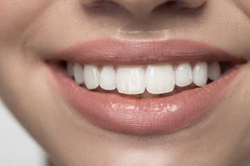 Happy smile. Close up of smiling woman mouth with white healthy teeth. Oral treatments concept