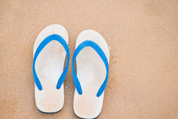 Fototapeta na wymiar White sandal on the sand beach