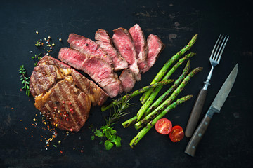 Roasted rib eye steak with green asparagus