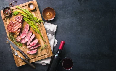 Tuinposter Roasted rib eye steak with green asparagus and wine © Alexander Raths