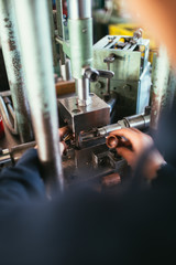 Metallurgy heavy industry. Factory for production metal parts. Close up shot of workers hand.