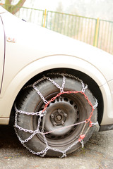 Snow chains mounted on car wheels