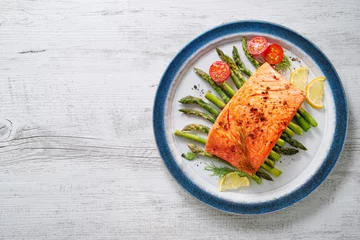 Foto auf Acrylglas Grilled salmon garnished with green asparagus and tomatoes © Alexander Raths