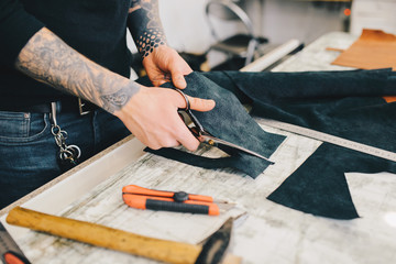 Man working with leather using crafting DIY tools
