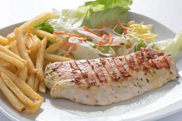 Tasteful roasted turkey steak with chips and vegetable