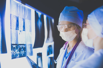 Two female women medical doctors looking at x-rays in a hospital