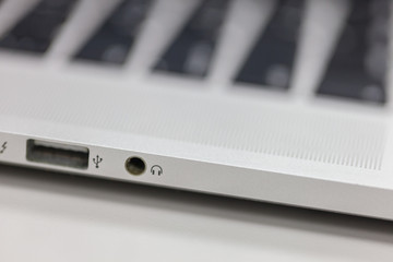 Plug in the headphones on the laptop