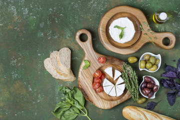 Camembert and olives on wooden boards