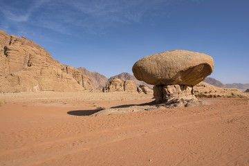 Fototapeta na wymiar Mushroom rock in Wadi Rum desert with long shadow in Jordan