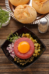 Beef steak tatare with egg, onion, cucumber and capers