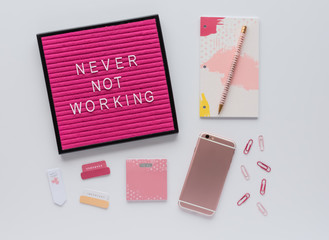 Pink Letter Board Quote on Desk with Agenda, Colorful Office Accessories and Mobile Phone