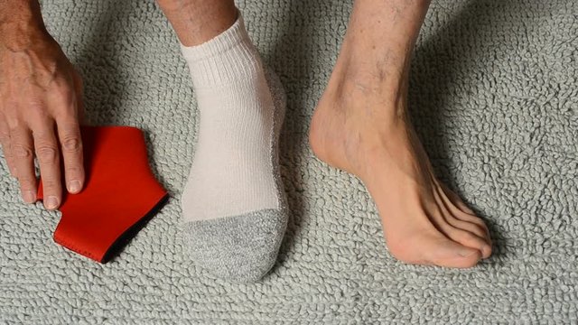 man putting on ankle support