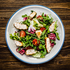 Caesar salad on wooden table 