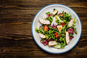 Caesar salad on wooden table 