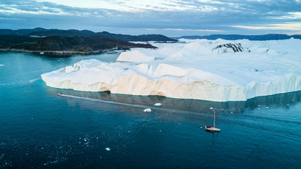 Field of icebergs. Boats near ice. Drone view