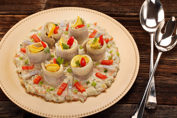 Rolled herrings with fish salad and lemon