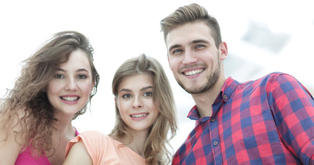 Fototapeta premium closeup of three young people smiling on white background