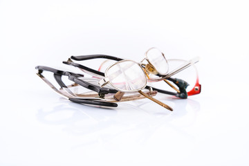 Group of old broken eyeglasses on white background. Move for create place for text. Concept - update your old accessory