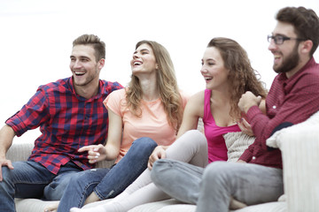 young friends sitting on the couch and rooting for their favorite team