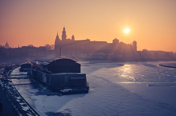 Fototapeta Krakow, Poland, Wawel Castle and Wawel cathedral in the winter over frozen Vistula river, sunrise obraz