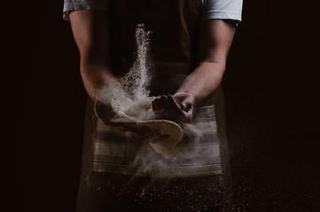 Fototapeta na wymiar Photo of flour and men hands with flour splash with dough for pizza