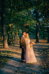 portrait of happy newlyweds during a walk in the forest