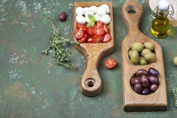 snacks: olives, mozzarella and tomatoes
