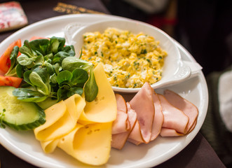 Breakfast with egg, ham, cheese and cucumbers. selective focus