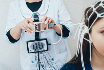 Doctor and patient with encephalography electrode.