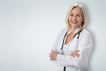 Smiling medical woman doctor. Isolated over gray background
