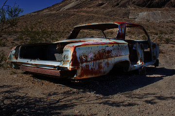 rusted out old car with red roof