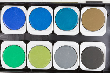 detail of new watercolor box with blue, green, brown and black color