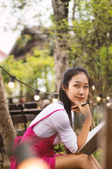 Fototapeta premium Asian women writing diary in notebook.